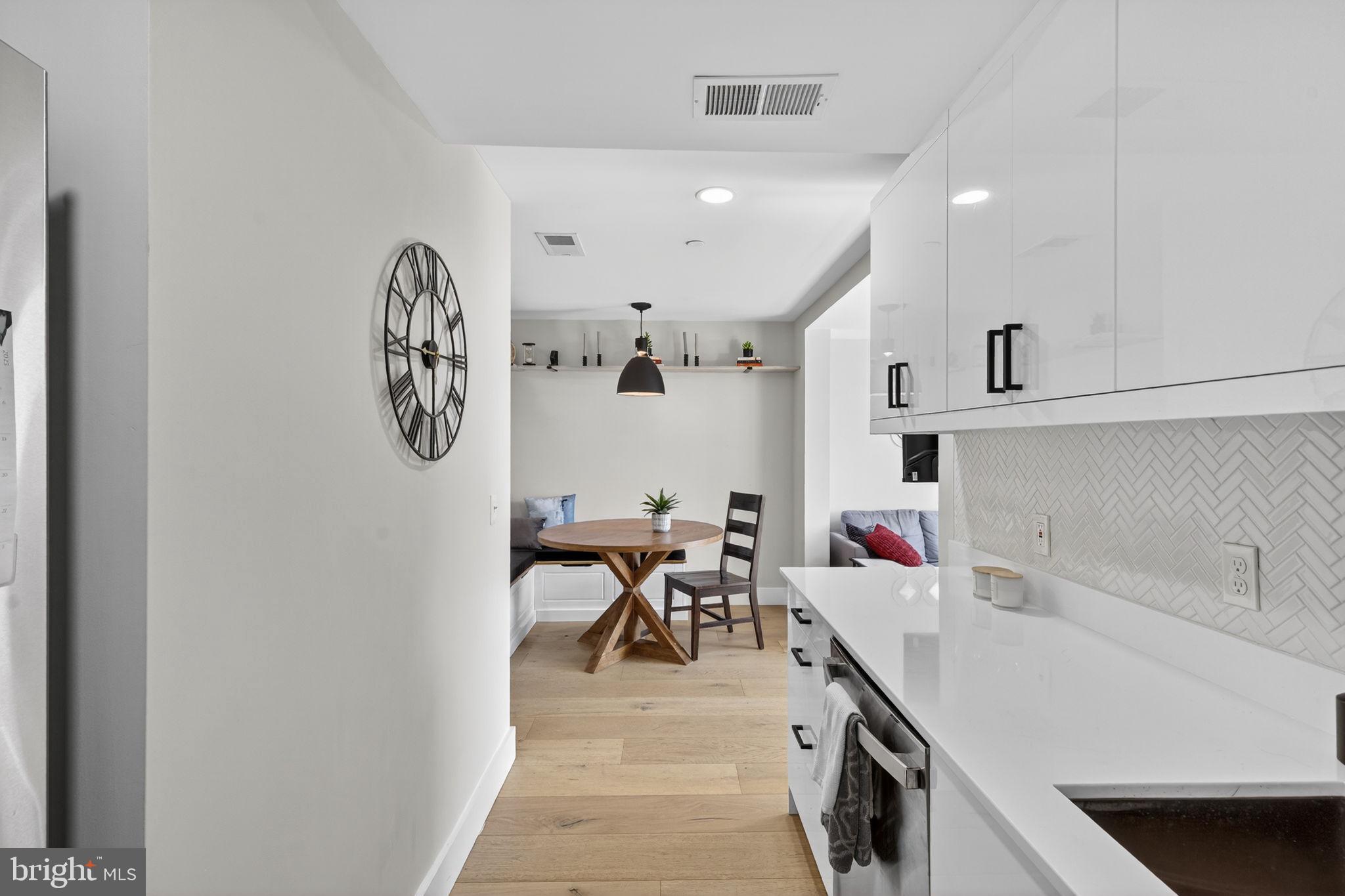 919 12th Street Northeast, Unit 305 Washington, DC 20002 - Photo 17 of 31 a kitchen with a refrigerator and white cabinets
