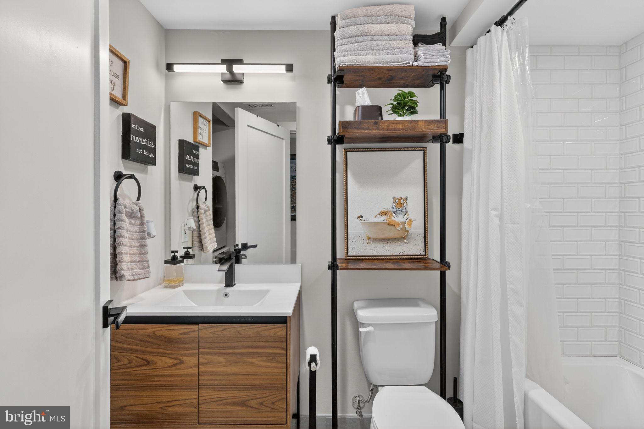 919 12th Street Northeast, Unit 305 Washington, DC 20002 - Photo 22 of 31 a bathroom with a granite countertop sink toilet and shower