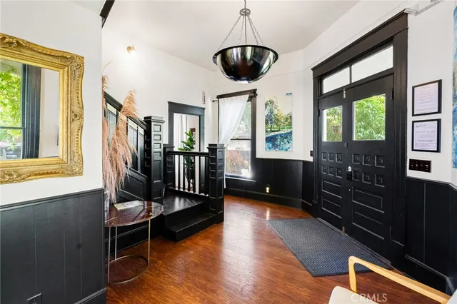 a view of a hallway with furniture and a window