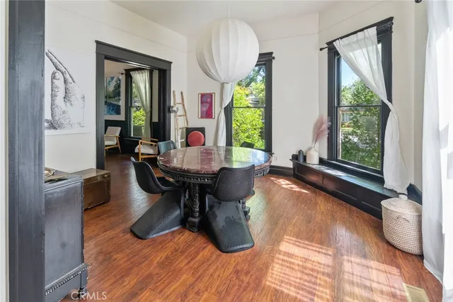 a view of a dining room with furniture window and wooden floor