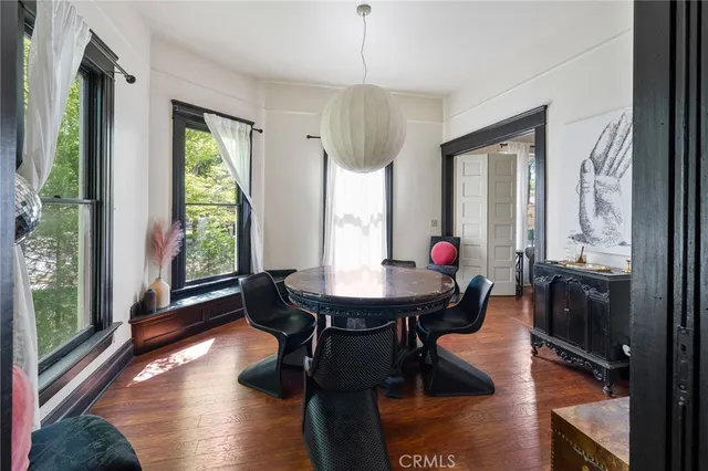 a view of living room with furniture and wooden floor