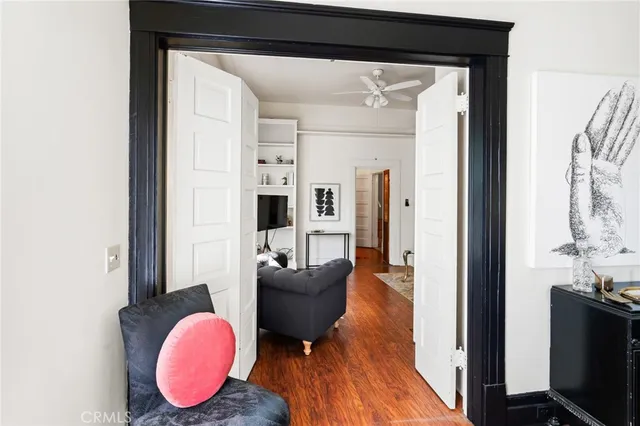 a living room with furniture a flat screen tv and a table