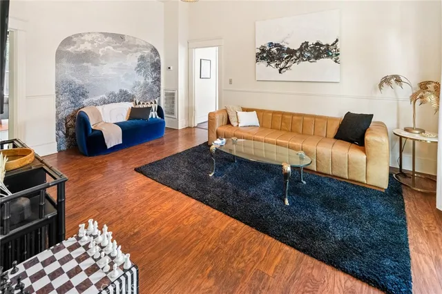 a bedroom with a large bed and a potted plant