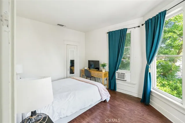 a bedroom with a bed and a window with outer view