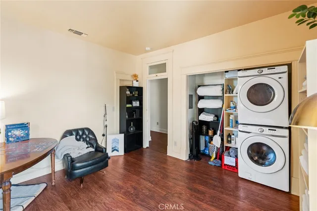 a bedroom with a large bed and a potted plant