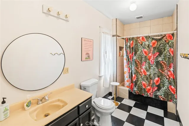 a bedroom with a large bed and a potted plant