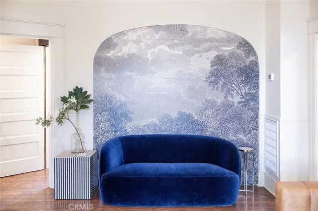 a living room with a couch and a potted plant