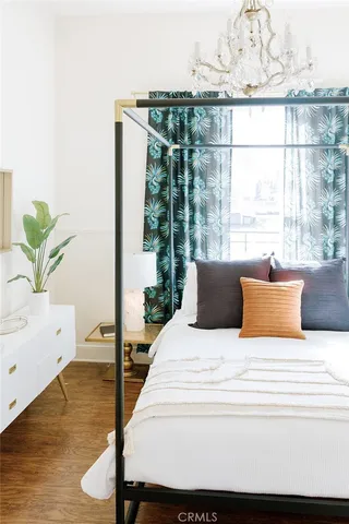 a bedroom with a bed and a painting on the wall