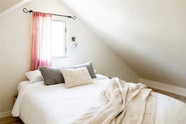 a bedroom with a bed and a television