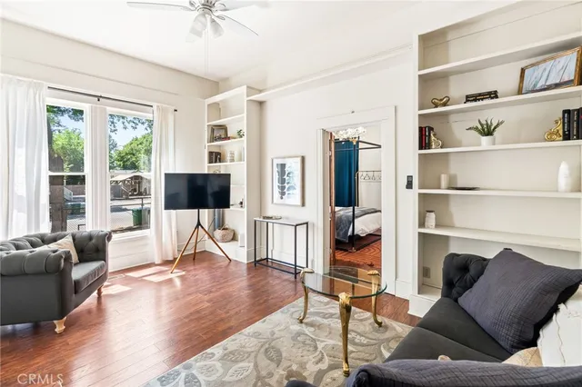 a living room with furniture or wooden floor and a large window