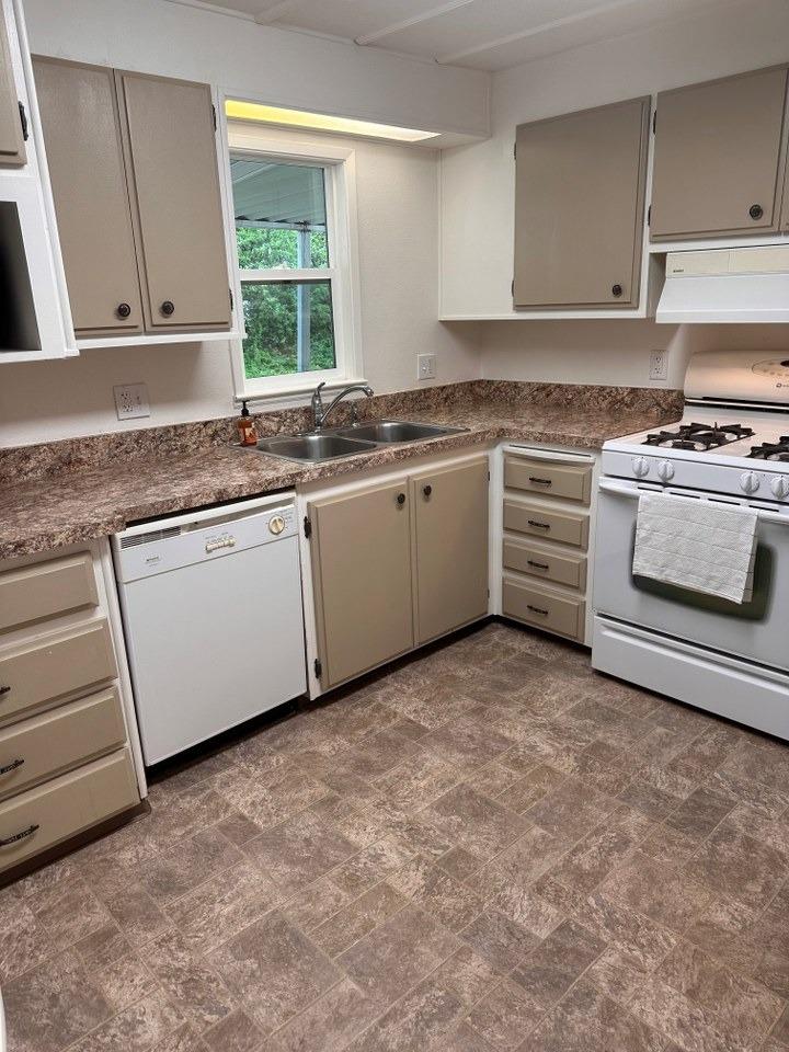 39678 Fresno Flats Road, Unit 39 Oakhurst, CA 93644 - Photo 12 of 34 a kitchen with granite countertop a stove a sink and a counter space
