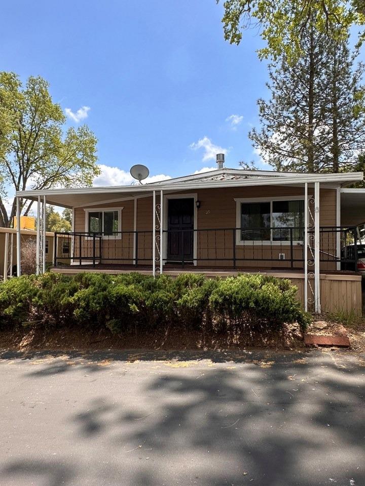 39678 Fresno Flats Road, Unit 39 Oakhurst, CA 93644 - Photo 2 of 34 a front view of a house with garden