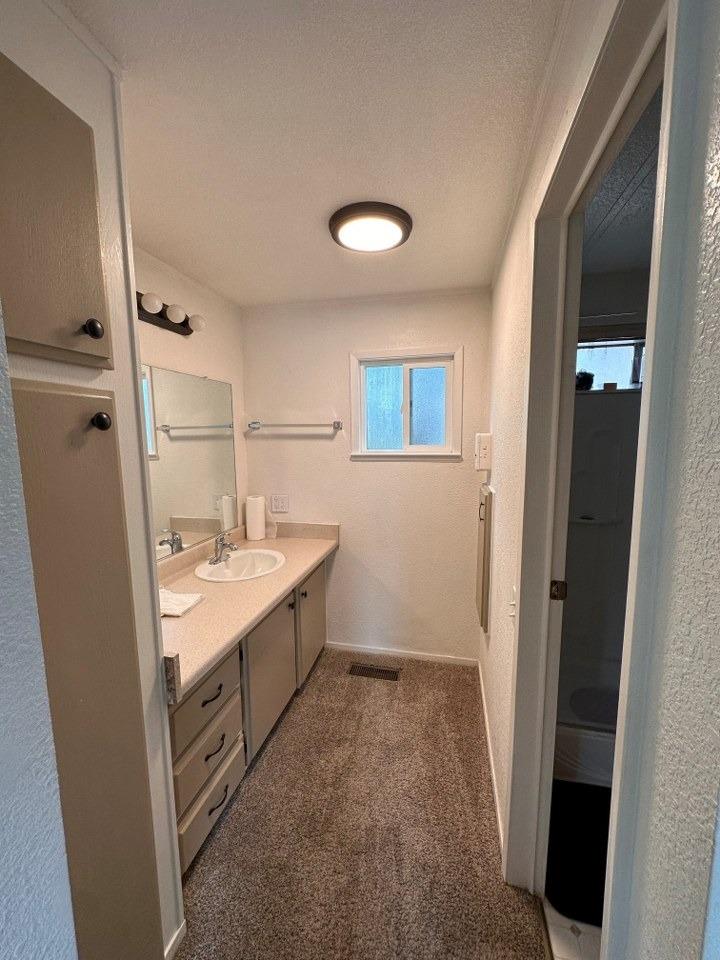 39678 Fresno Flats Road, Unit 39 Oakhurst, CA 93644 - Photo 23 of 34 a bathroom with a sink a toilet and shower