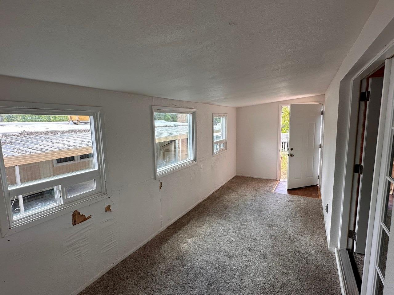 39678 Fresno Flats Road, Unit 39 Oakhurst, CA 93644 - Photo 28 of 34 an empty room with windows