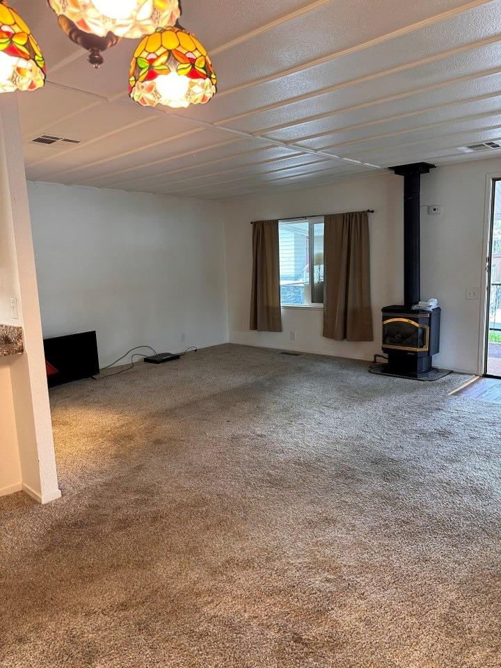 39678 Fresno Flats Road, Unit 39 Oakhurst, CA 93644 - Photo 6 of 34 a view of an empty room with a window