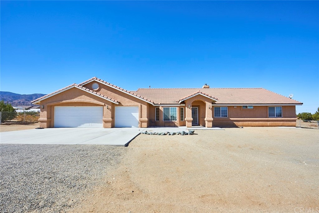 9656 Mescalero Road Phelan, CA 92371 - Photo 1 of 1 a front view of a house with a yard