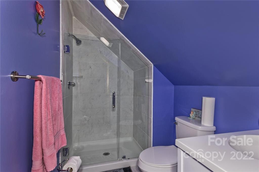 129 Moonlight Drive Sylva, NC 28779 - Photo 15 of 41 a bathroom with a shower curtain and a toilet