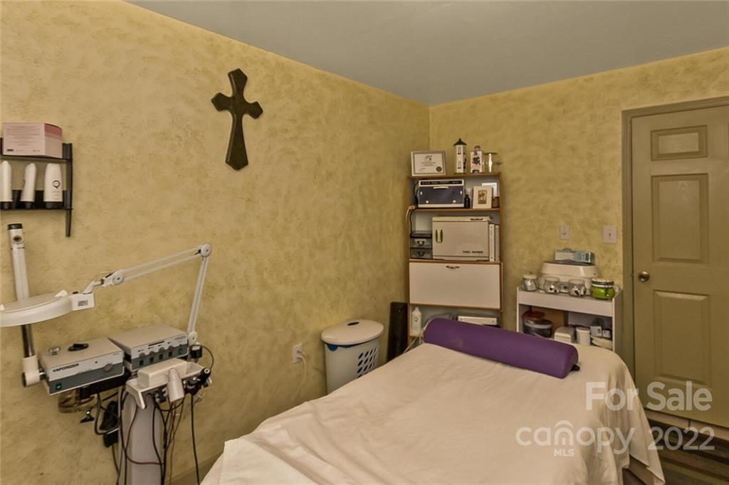 129 Moonlight Drive Sylva, NC 28779 - Photo 32 of 41 a bedroom with a bed and a wall painting