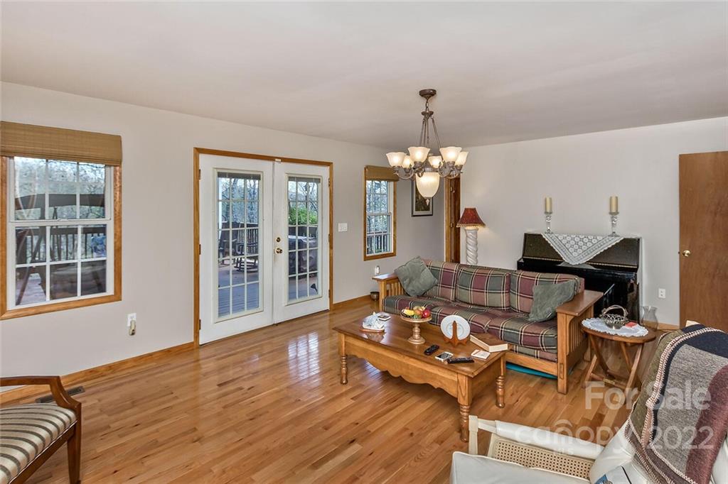 129 Moonlight Drive Sylva, NC 28779 - Photo 5 of 41 a living room with furniture and a chandelier