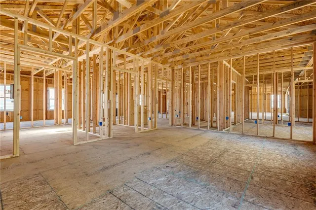 a spacious bedroom with a bed and a chandelier