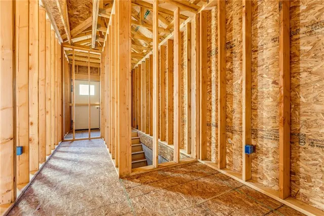 a view of an empty room with a window and bathroom