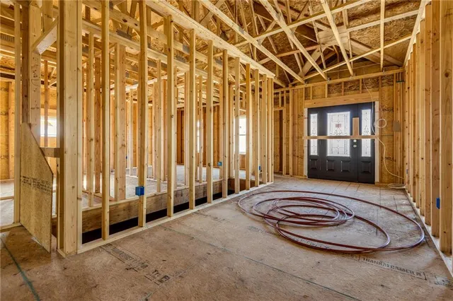 a view of a bedroom with sliding door and wooden floor
