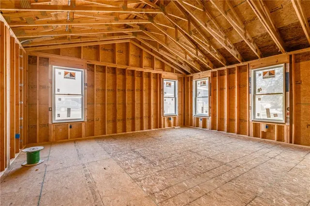 a kitchen with kitchen island a sink stainless steel appliances and white cabinets