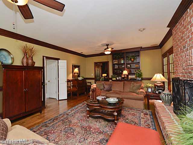 8231 Stafford Mill Road Oak Ridge, NC 27310 - Photo 11 of 16 Den/Family/Great Room. Den area includes gas log fireplace with detailed brick accents, built in bookcases/storage and more. Two ceiling fans keep this room cool and comfortable.