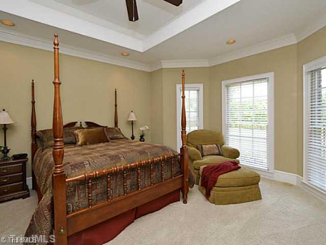 8231 Stafford Mill Road Oak Ridge, NC 27310 - Photo 15 of 16 2nd Bedroom. Located on the main level, this large guest bedroom has its own bath with tile floors, granite tops and step in tile shower. This is PERFECT for those older guest who don t like navigating stairs.