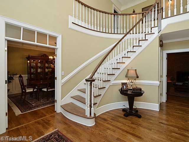 8231 Stafford Mill Road Oak Ridge, NC 27310 - Photo 5 of 16 Entry. Upon entering you are greeted by the grand curved staircase with 18 foot foyer. Stair leads to two spacious bedroom suites each with attached bath and ENORMOUS walk in closets. Future 15x40 bonus room is also upstairs.