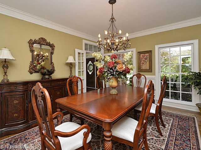 8231 Stafford Mill Road Oak Ridge, NC 27310 - Photo 9 of 16 Dining Room. A dining room that seats 8 or 10- you got it! Detailed wainscoting and crown mold delight as your guests enjoy your meals in this delightful space.