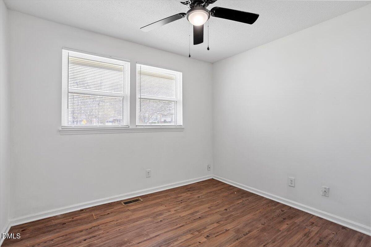 2000 Waters Drive Raleigh, NC 27610 - Photo 11 of 20 an empty room with wooden floor and windows