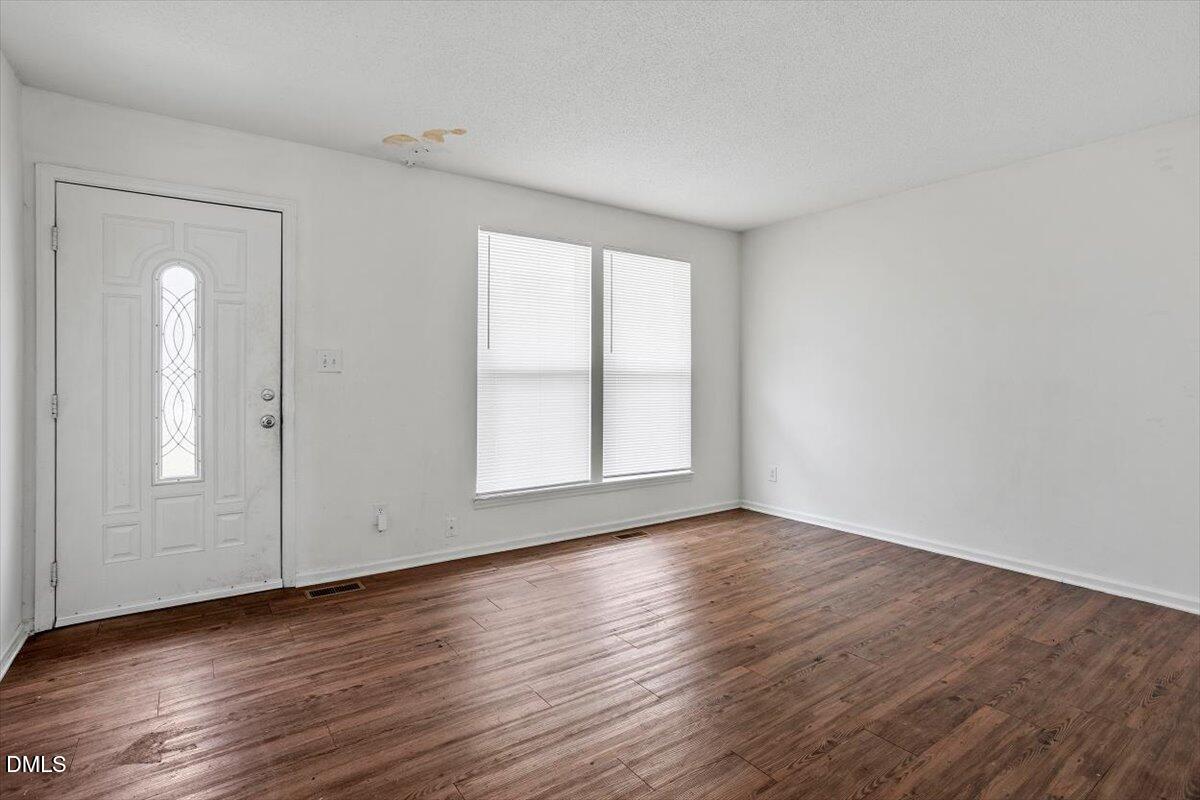 2000 Waters Drive Raleigh, NC 27610 - Photo 2 of 20 an empty room with wooden floor and windows