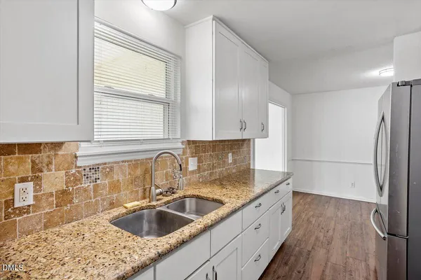 a kitchen with a sink and a refrigerator