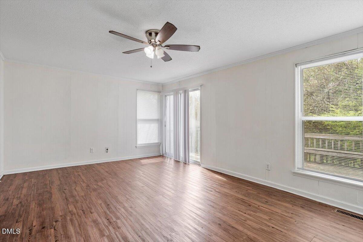 2000 Waters Drive Raleigh, NC 27610 - Photo 7 of 20 a view of an empty room with wooden floor and a window
