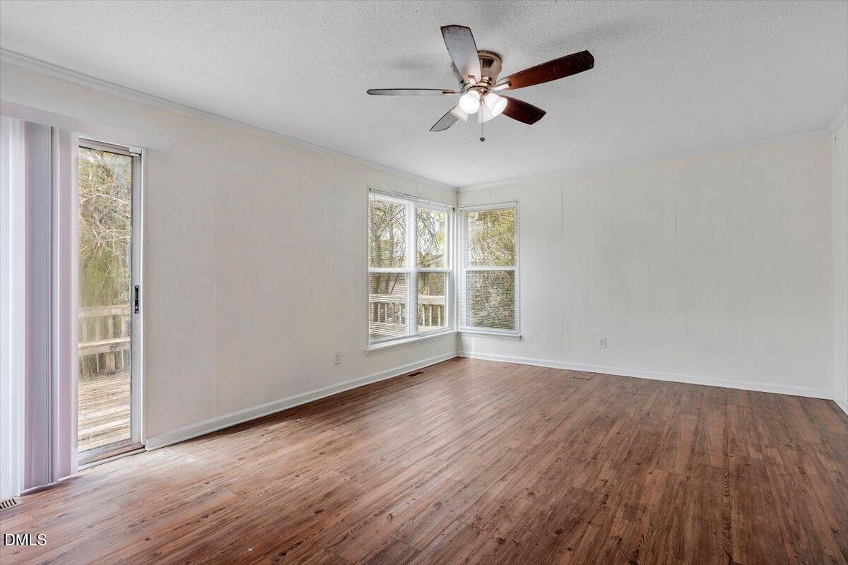 2000 Waters Drive Raleigh, NC 27610 - Photo 8 of 20 a view of an empty room with wooden floor and a window