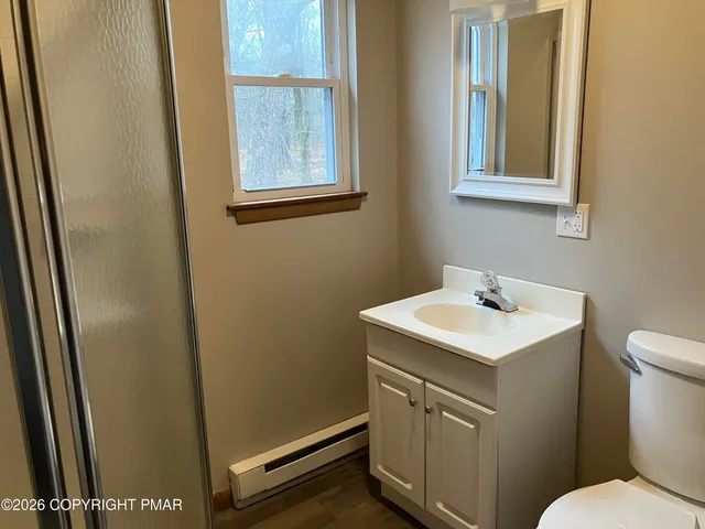 a bathroom with a sink a toilet and a mirror