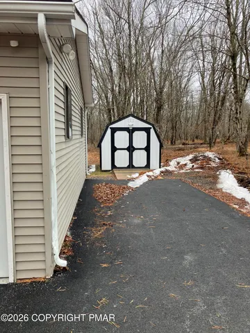 a view of backyard with a garden and entertaining space