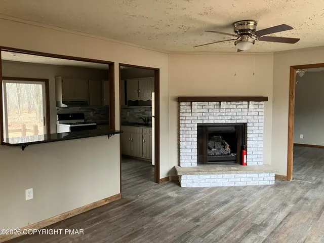 a living room with furniture and a fireplace