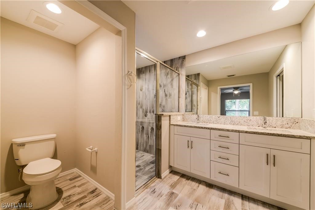8072 Albatross Road Fort Myers, FL 33967 - Photo 9 of 14 a bathroom with a granite countertop sink toilet and shower