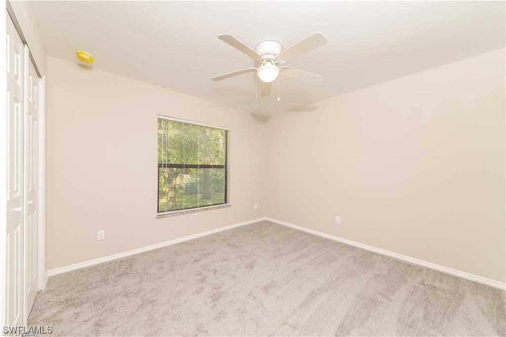 8072 Albatross Road Fort Myers, FL 33967 - Photo 10 of 14 an empty room with windows and fan