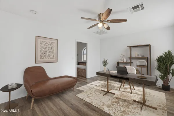 a living room with furniture and a potted plant