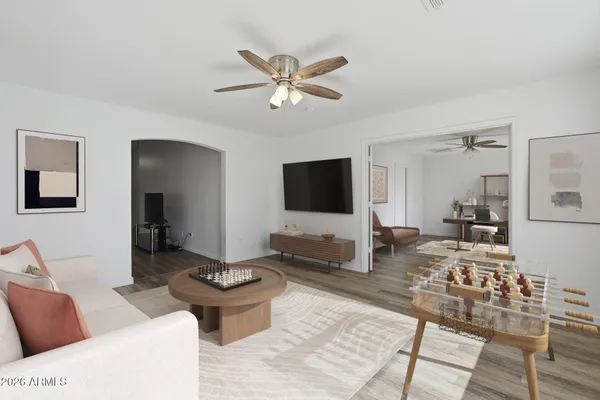 a living room with furniture a flat screen tv and a large window