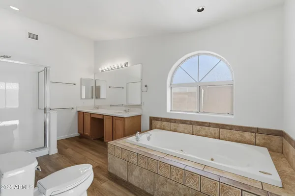 a bathroom with a tub a toilet and a sink