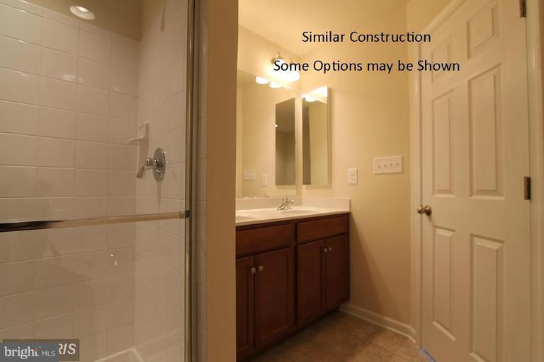 0 Rumbling Rock Road Hedgesville, WV 25427 - Photo 15 of 26 a bathroom with a double vanity sink mirror and shower