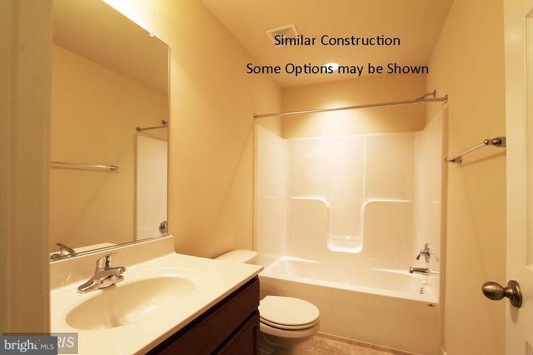 0 Rumbling Rock Road Hedgesville, WV 25427 - Photo 21 of 26 a bathroom with a bathtub shower sink vanity and toilet