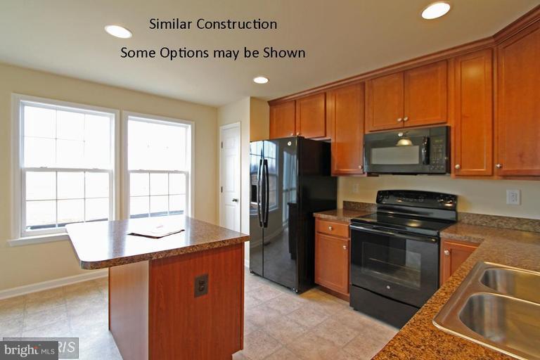 0 Rumbling Rock Road Hedgesville, WV 25427 - Photo 6 of 26 a kitchen with stainless steel appliances granite countertop a refrigerator stove and sink