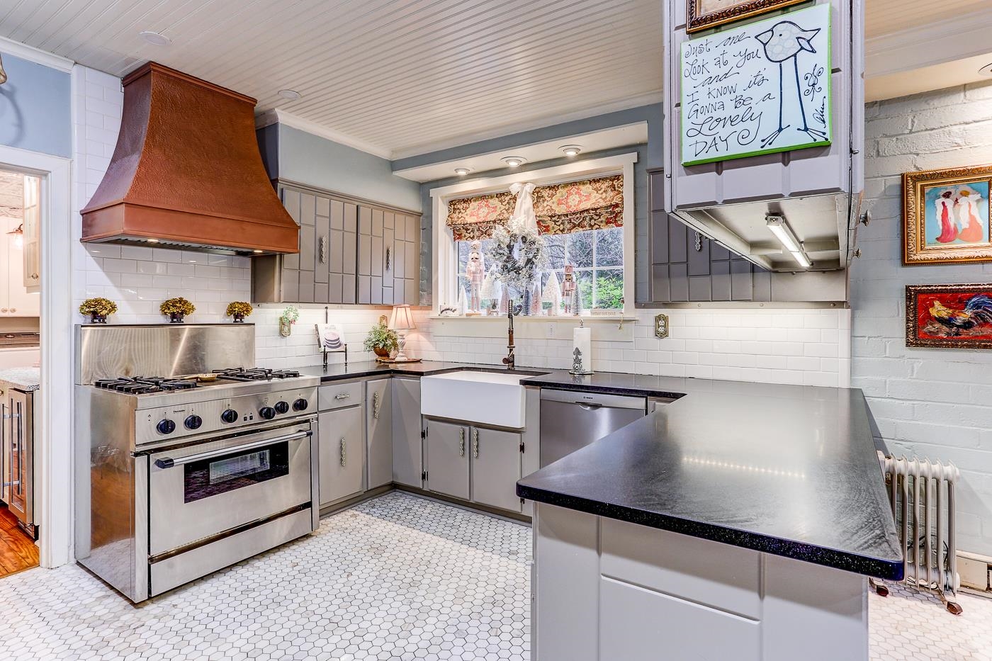 450 South Goodlett Street Memphis, TN 38117 - Photo 12 of 37 Kitchen featuring appliances with stainless steel finishes, custom range hood, gray cabinetry, radiator, and dark countertops