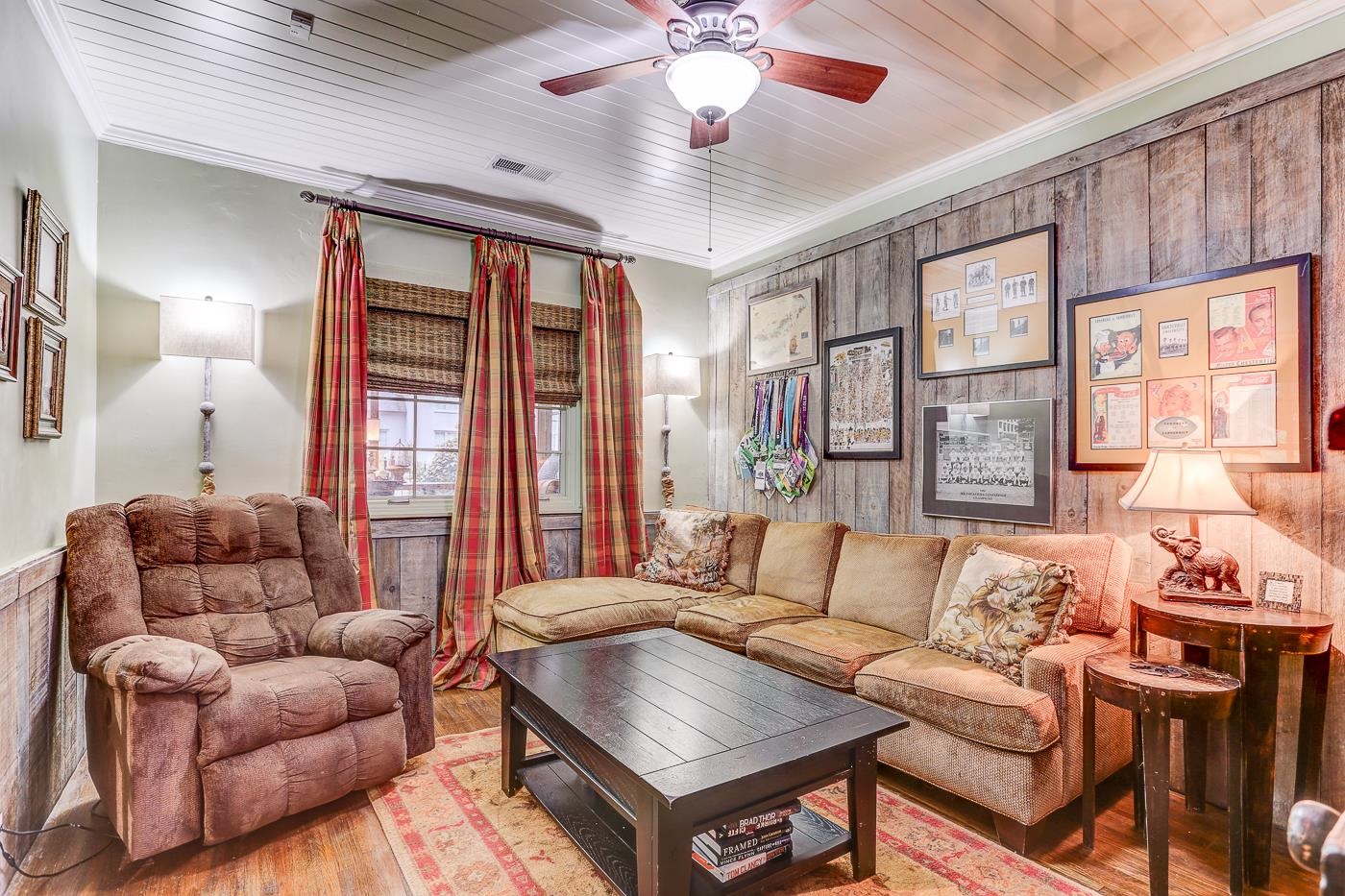 450 South Goodlett Street Memphis, TN 38117 - Photo 18 of 37 Living area with crown molding, wooden walls, hardwood / wood-style flooring, wooden ceiling, and a ceiling fan