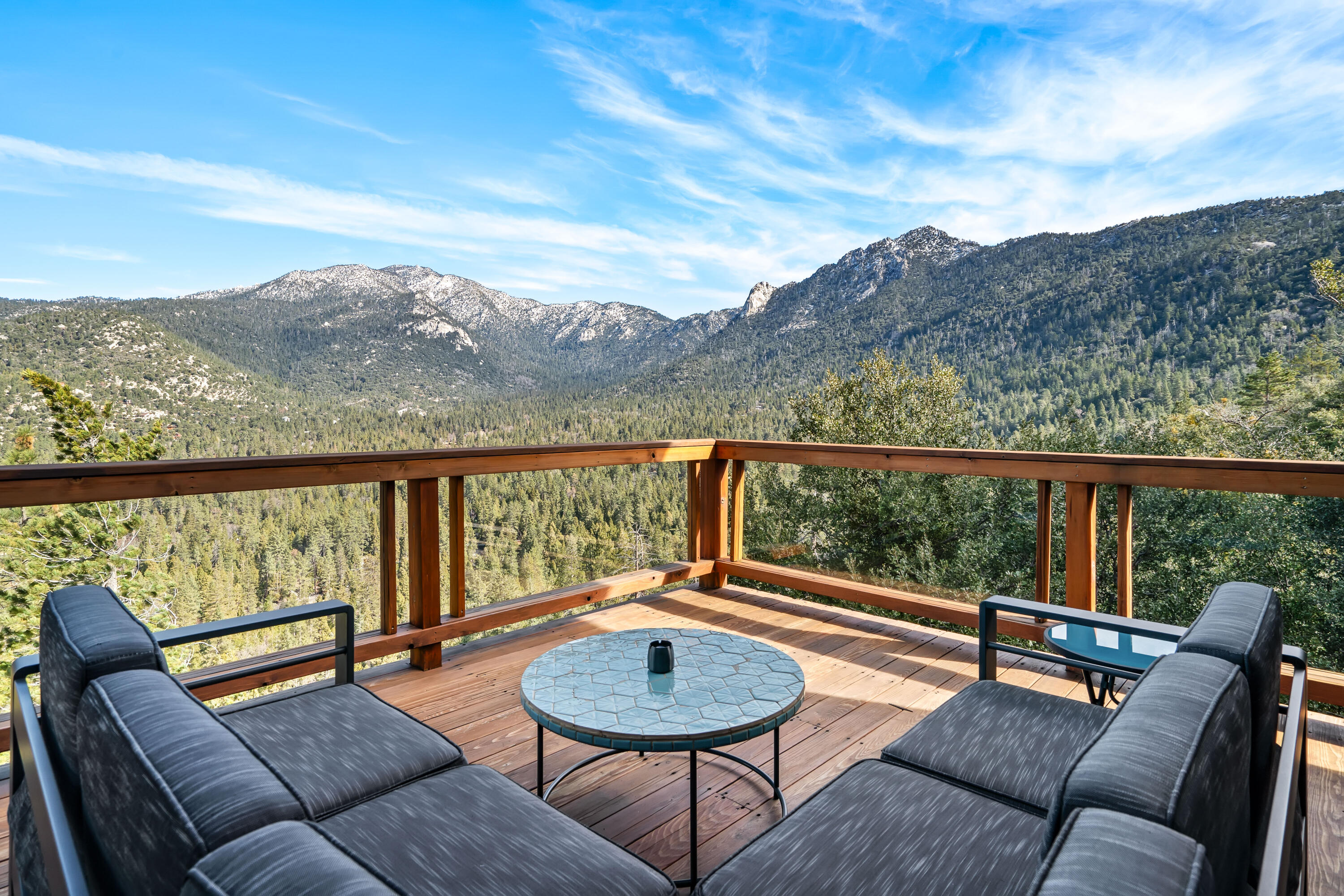 a balcony with outdoor seating and city view